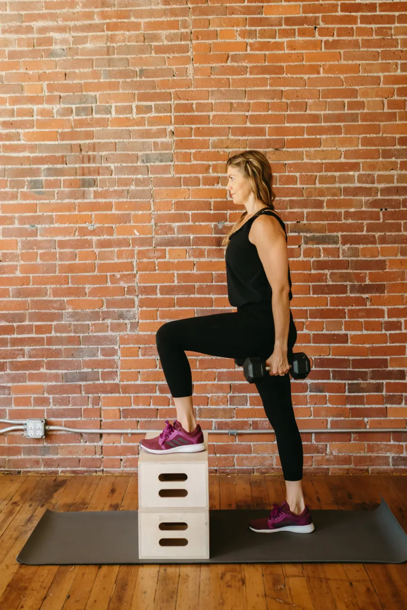 Michelle doing a step-up with dumbbells